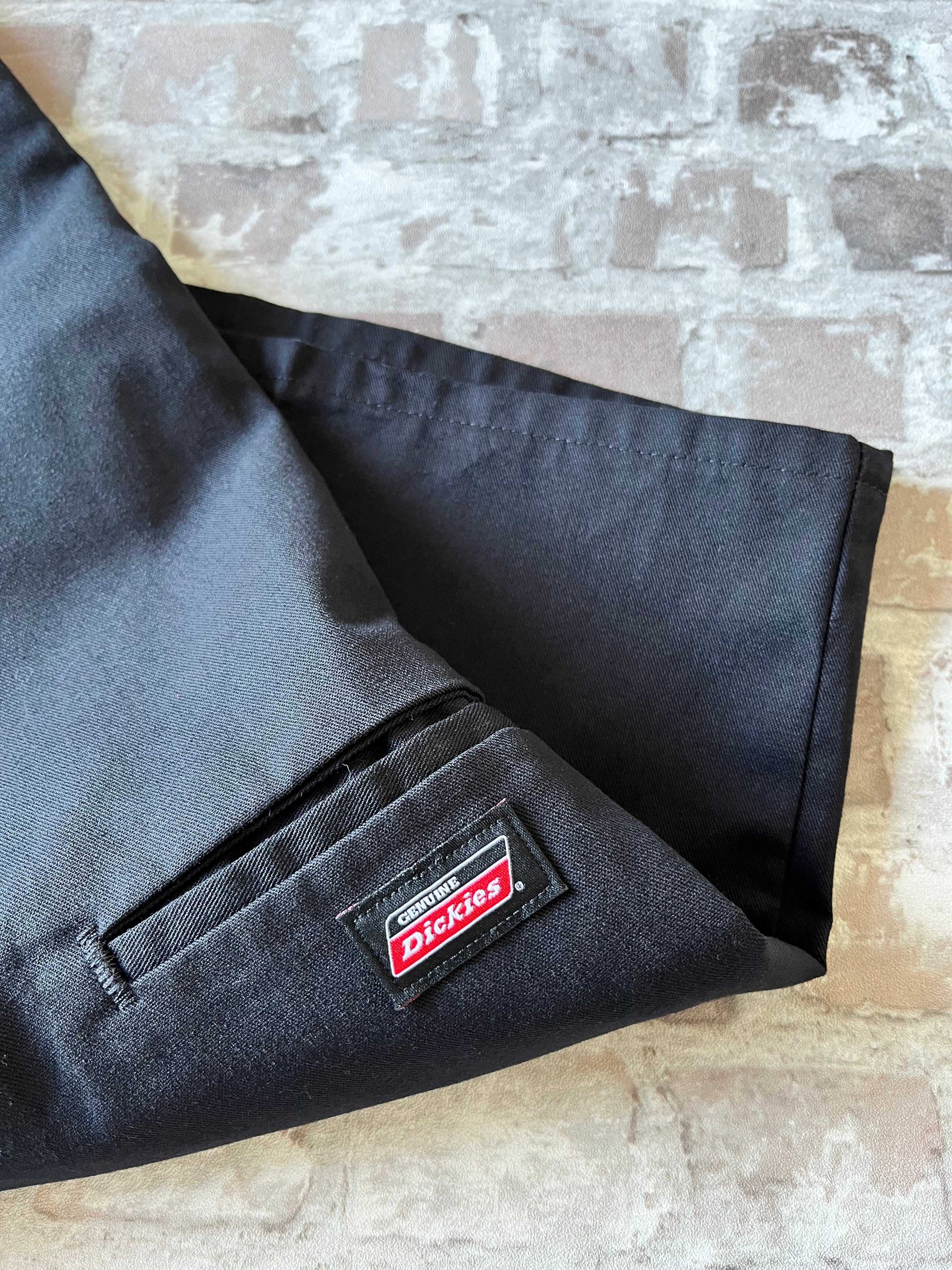 Short de travail Dickies 13 pouces Loose Fit noir avec plis permanents et poche téléphone latérale, présenté à plat, détail poche et logo
