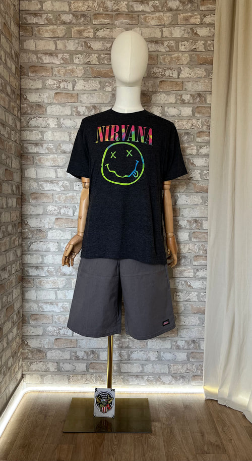 Bermuda Dickies Gris Coupe Skateur  Loose Fit et tshirt Nirvana Smiley néon de face sur mannequin, un patch La Barbuda posé au sol