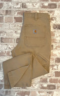 Pantalon de travail beige tan Carhartt Rugged Flex en toile canvas stretch, présenté à plat