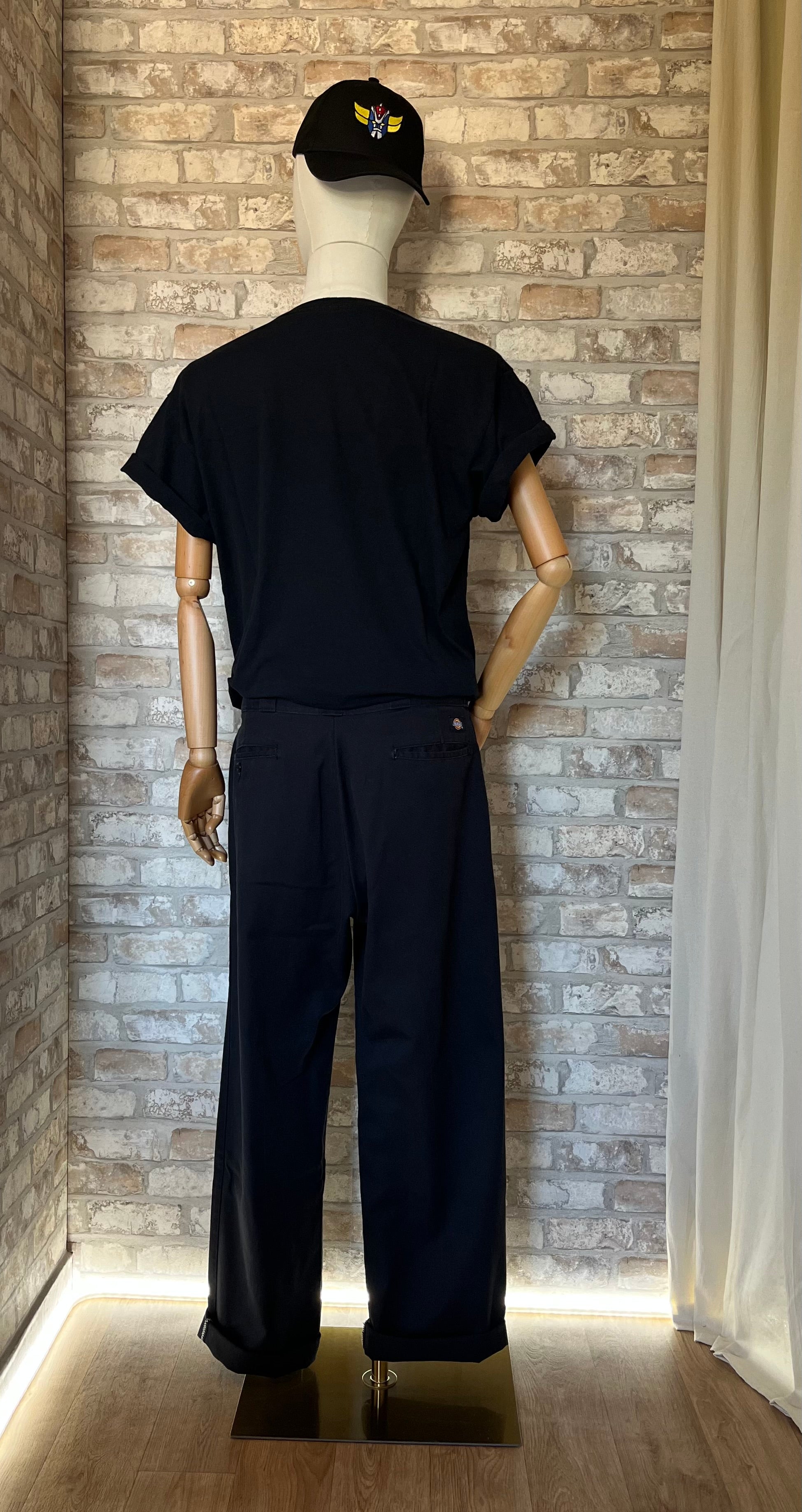 Pantalon Dickies 874 Faded Black porté sur mannequin avec un Graphic tee et une casquette Grafitee Goldorak , de dos