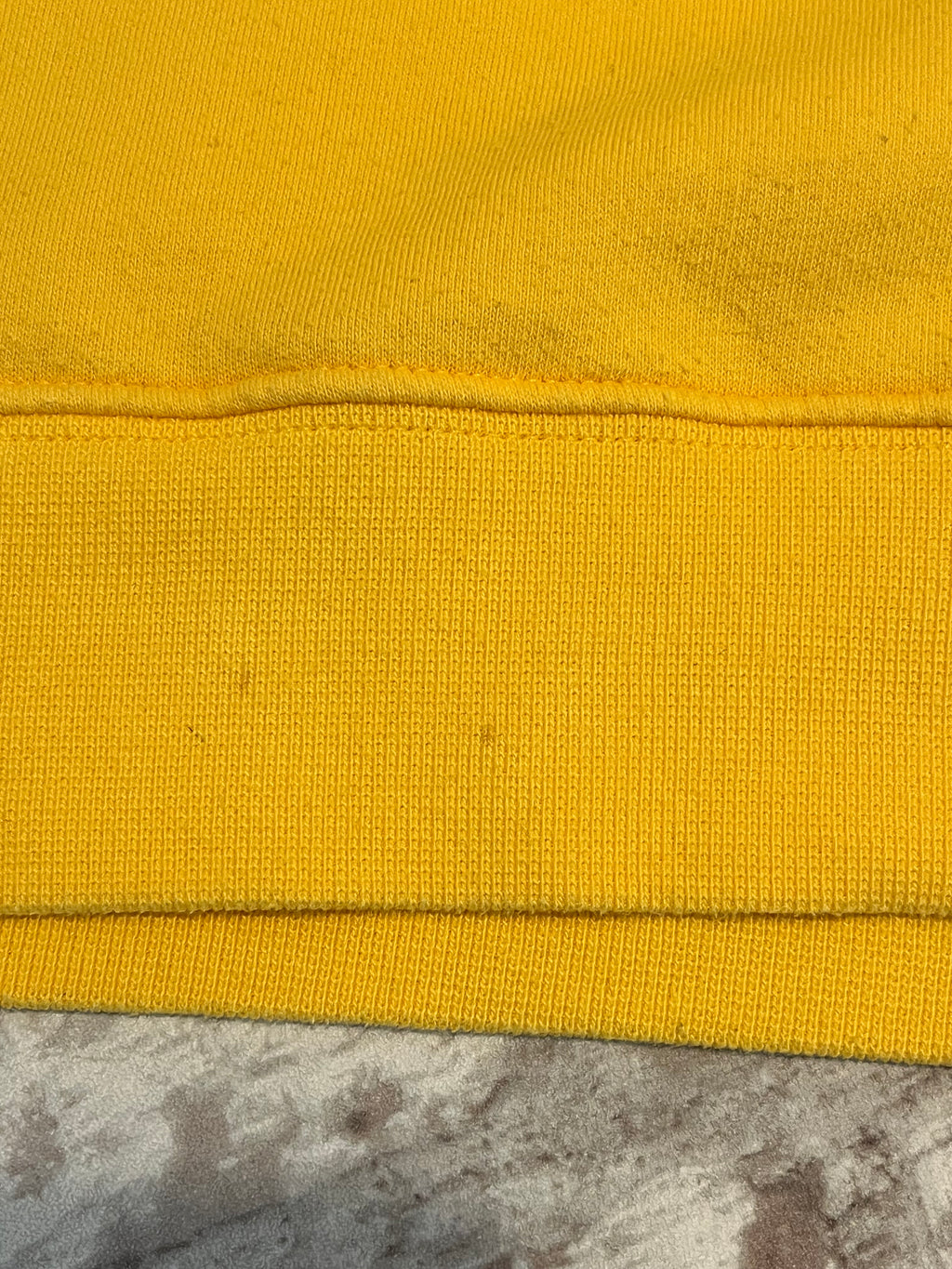 Sweat col rond vintage Nike jaune vif avec le logo Swoosh brodé sur la poitrine, présenté à plat, focus taches bord-côte