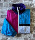 Veste rétro zippée Blair Boutique au motif colorblock néon et pastel, présentée pliée à plat.