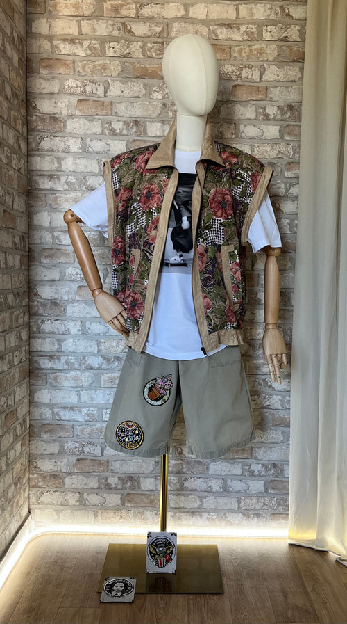 Gilet sans manches vintage en soie Fuda International à motifs paisley porté sur un t-shirt blanc de nonne sur un skate et un bermuda Dickies avec des patchs La Barbuda.